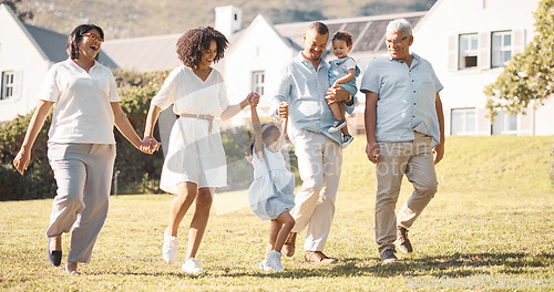 Image of Holding hands, children and a blended family walking in the backyard of their home together during summer. Grandparents, parents and kids on grass in the garden of a house for bonding during a visit
