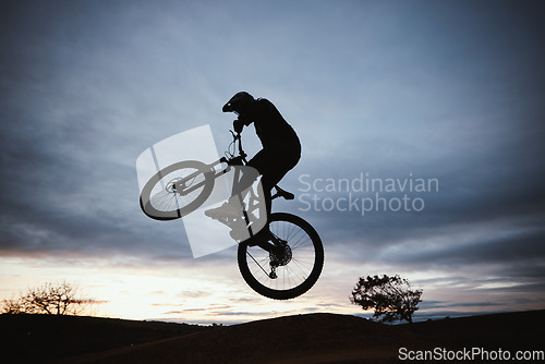 Image of Motorcycle, sunset and jump with sport with sky or action with training in outdoor for race or risk. Adventure, silhouette and dirt bike with speed in nature with freedom or power in desert on hill.