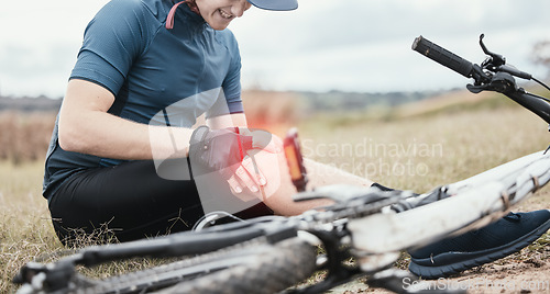 Image of Injury, accident and a man with knee pain and a bike in nature after cycling or travel for fitness. Sports, cardio inflammation and a biker with a medical emergency on a bicycle in the countryside