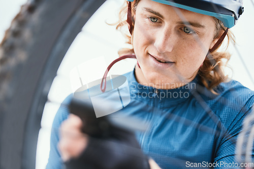 Image of Bike repair, fitness and man with a wheel in nature for a change, mechanic or travel for sports. Service, professional and a male biker working on a bicycle for riding, cardio or exercise in morning