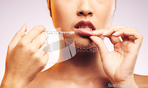 Image of Beauty, lip filler and hands with botox injection, plastic surgery and portrait of cosmetic dermatology in studio background. Lips of woman, syringe and model with aesthetic facial treatment