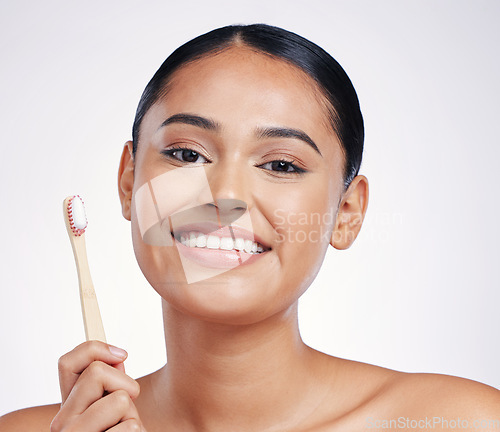 Image of Portrait, smile and woman with a toothbrush, self care and dental hygiene against a white studio background. Face, female person or model with oral hygiene, toothpaste or cleaning mouth with wellness