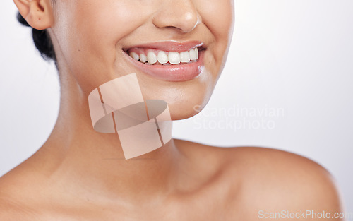 Image of Closeup, mouth and woman with skincare, dermatology and grooming against a white studio background. Zoom, female person and model with a smile, lips and smooth skin with a glow, shine and dental care