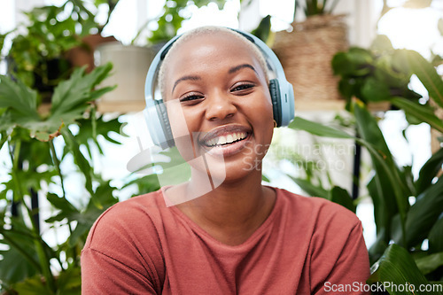 Image of Relax, music and portrait of black woman with plants in home for wellness, happiness and calm. Nature, headphones and face of female person listening to audio with ferns, leaves and house plant