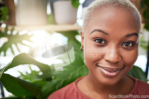 Image of Portrait, plant and flare with a black woman gardener in her home for sustainability or green growth. Face, beauty and smile with a happy young female person in a nursery for eco conscious gardening