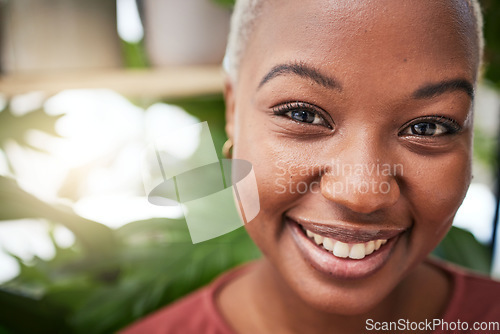 Image of Portrait, plants and smile with a black woman gardener in her home for sustainability or green growth. Face, beauty and flare with a happy young female person in a nursery for eco friendly gardening