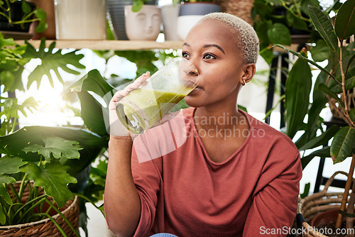 Image of Healthy, black woman and drinking a green smoothie for nutrition with vegetables for supplement. Girl, detox and enjoying a vegan drink for home or weightloss with vitamin or plants and fruit shake.