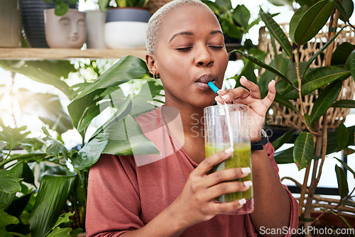 Image of Nutrition, drinking and black girl with green smoothie for diet with plants for wellness or weightloss. Healthy, woman and enjoy a detox drink with vegetables for vitamins with supplement in home.