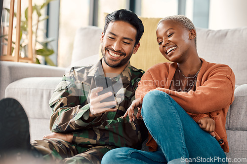 Image of Army man, interracial couple and return with phone meme at home with laugh and video streaming. Lounge, young people and mobile scroll together in a house sitting on a lounge ground with soldier