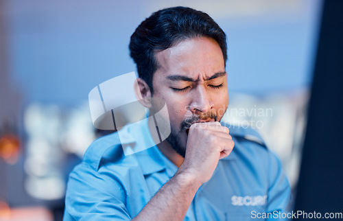 Image of Security officer, man and tired at work with uniform or late night working for career in protection. Exhausted, safety professional and guard with yawn or guy during shift at desk with burnout.