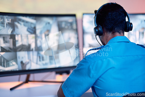 Image of Security guard, headphones and cctv monitor, communication and inspection service for building safety. Screen, video surveillance agency and law officer in control room listening and checking system.