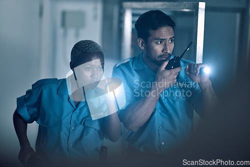 Image of Security, emergency and police investigate a crime in a store at night or in the evening for protection. Teamwork, walkie talkie and professional safety employees search a room for criminal danger