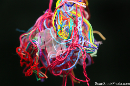 Image of Multicolored tangled threads for needlework on black background