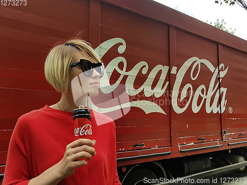 Image of Kyiv, Ukraine - July 6, 2017 Beautiful fashionable woman with model release drinking Coca-Cola soda