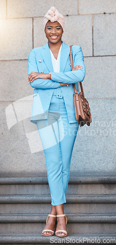 Image of Crossed arms, smile and portrait of businesswoman on stairs in the city by her office building. Happy, briefcase and full body of professional African female lawyer with confidence in an urban town.