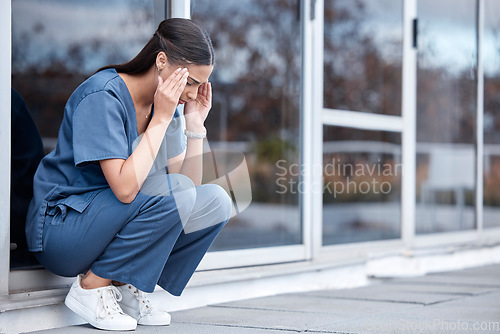 Image of Anxiety, doctor or a woman with a headache from healthcare, surgery mistake or death at a hospital. Sad, depressed and a tired female nurse with a migraine or burnout from medical career at a clinic