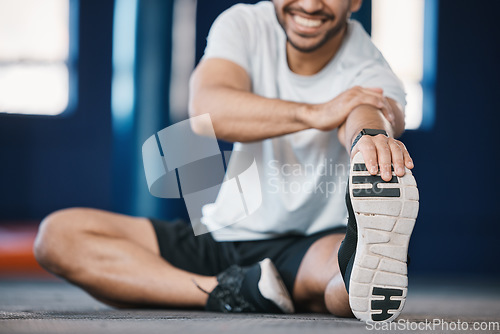 Image of Foot, exercise and stretching with a sports man in the gym getting ready for a cardio training routine. Fitness, health and warm up with a male athlete in preparation of a workout for wellness