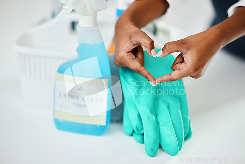 Image of Heart hands, cleaning and chemical detergent bottle, closeup of supplies and cleaner with hygiene. Care, support and health with disinfectant spray, housekeeping and person with tools to clean