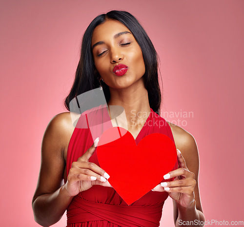 Image of Woman, paper heart and kiss in studio with lips, makeup and beauty with romantic sign by red background. Girl, fashion model and cardboard emoji with love for cosmetic, valentines day date or pout
