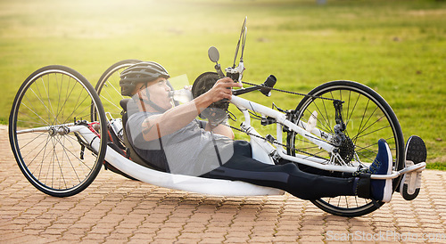 Image of Fitness, cycling and a man with a disability and on a bike for training, travel and exercise in nature. Sports, street and a person in a wheelchair bicycle for a workout, health or cardio in a park