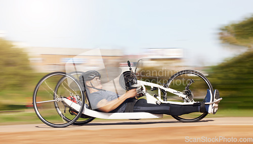 Image of Cycling, fitness and speed with man and handcycle in nature for training, sports and challenge. Exercise, workout and motion blur with person with a disability in park for cardio and health