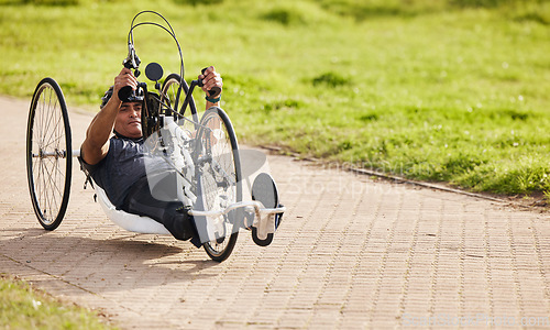 Image of Sports, fitness and man with disability on bike, training for competition with motivation and cycling exercise. Path, cycle workout and person on recumbent bicycle for outdoor race track challenge.