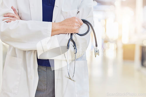 Image of Hands, arms crossed and doctor with stethoscope for cardiology, healthcare or wellness in hospital. Medical professional, expert and heart equipment to monitor for health checkup with confidence.