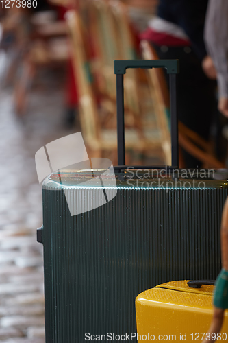 Image of Luggage bag on the city street ready to pick by airport transfer taxi car.