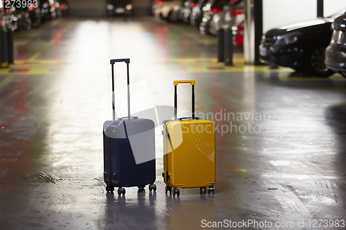 Image of Luggage bag on the city street ready to pick by airport transfer taxi car.