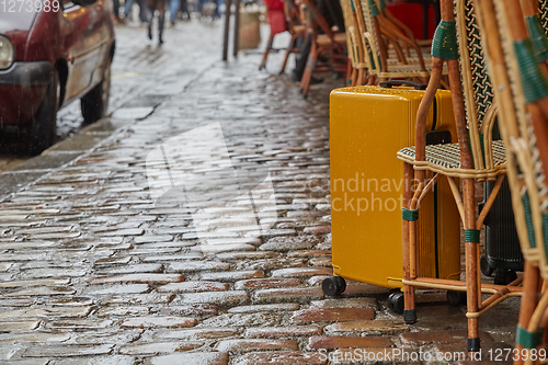 Image of Luggage bag on the city street ready to pick by airport transfer taxi car.