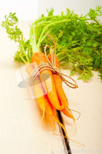 Image of baby carrots bunch tied with rope