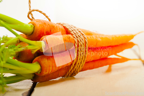 Image of baby carrots bunch tied with rope