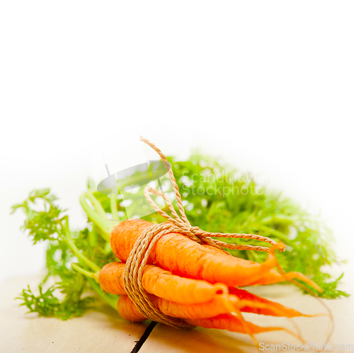 Image of baby carrots bunch tied with rope