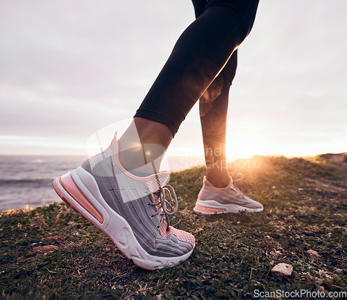 Image of Shoes, closeup and beach ground for fitness, workout and training to start a run. Outdoor, sunset and feet with sports by the sea and ocean for exercise and running in nature with sunshine by sky