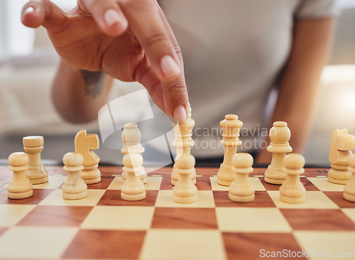 Image of Chess, game and hand of woman with board moving piece for strategy, thinking and challenge. Competition, winning and zoom of hands of person with chessboard in living room for playing to checkmate