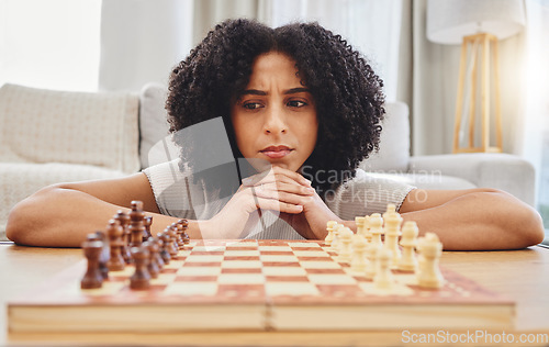 Image of Chess, thinking and face of woman with game for strategy, problem solving and challenge at home. Competition, planning move and female person with chessboard in living room ready for playing games