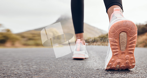 Image of Shoes, athlete and road by a mountain outdoor ready to start a run for health and wellness. Feet, person and running fitness for workout, training and exercise with sport and active on ground ashalt