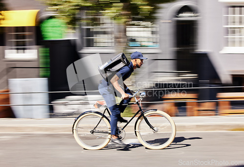 Image of Delivery man, bicycle and motion blur in city for fast logistics, quick distribution service and order. Courier, guy or travel with speed on bike, cycle and transportation for package in urban street