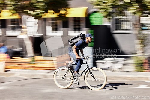 Image of Delivery, man or motion blur on bike in city for quick logistics, service or fast food order. Courier, postman or travel for speed on bicycle transportation with parcel, package or trip in urban road