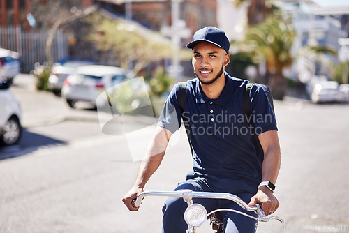 Image of Bicycle, delivery and city, man in street with smile and carbon neutral transport service with backpack. Happiness, eco friendly urban distribution and bike courier on road for sustainable logistics.