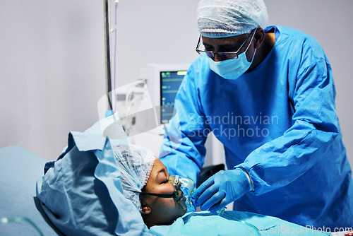 Image of Healthcare, doctor and patient with oxygen in emergency surgery, professional care and hospital bed. Breathing, help and air, surgeon with person in operation, mask to check health in medical results