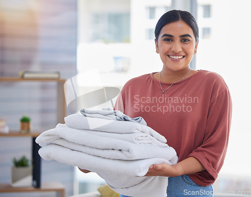 Image of Cleaning, laundry and portrait of woman in living room for housekeeping service, clothes and fabric. Hospitality, happy and cleaner with person at home for maintenance, helping and washing