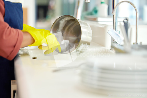 Image of Hands of woman, gloves and washing dishes in kitchen, brush chores and house work, cleaner service and home care. Cleaning, soap and water, housekeeper working in apartment with dirt and foam at sink