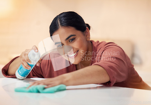 Image of Cleaning, table and smile with woman and spray dust for disinfection, hygiene and sanitary. Cleaner, maintenance and furniture with female person and bottle at home for maid, detergent and washing