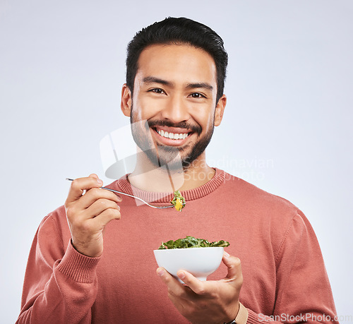 Image of Fruit, portrait and happy asian man in studio for health, wellness and detox on grey background. Breakfast, salad and face of guy nutritionist smile for healthy, clean or raw diet for vegan lifestyle