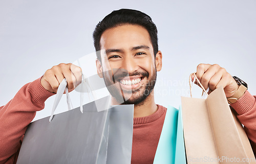 Image of Shopping bag, studio portrait and man with happiness, retail product and smile for fashion spree, sales or Black Friday choice. Face, gift present and happy male customer excited on white background