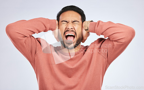 Image of Shouting, anxiety and hands on ears of asian man in studio with headache, brain fog or frustrated on grey background. Noise, stress and angry guy person scream for tinnitus, depression or vertigo