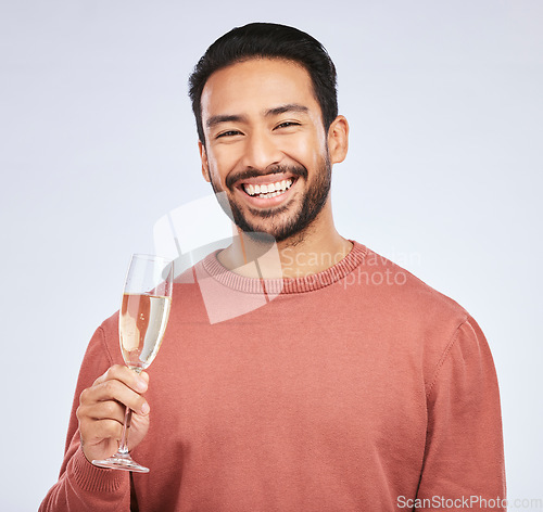 Image of Champagne, portrait and asian man with glass in studio for success, celebration or victory on grey background. Wine, face and happy guy winner celebrating promotion, announcement or competition prize