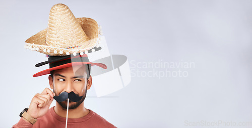 Image of Photo booth mockup, hat and face of man in studio with mustache for comic, humor and funny joke. Happy, Mexican party accessory and excited male person on gray background with sombrero for comedy