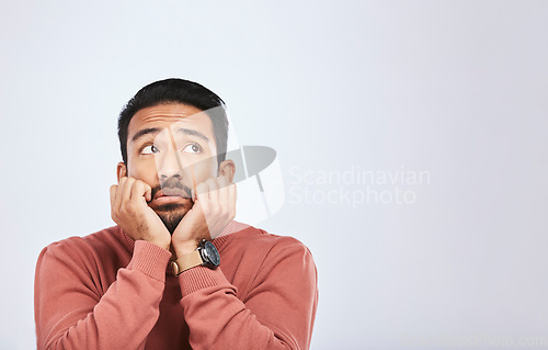 Image of Depression, thinking and sad asian man in studio for stress or broken heart, lonely or bored on grey background. Doubt, fear and face of male with anxiety, grief or trauma and mental health crisis